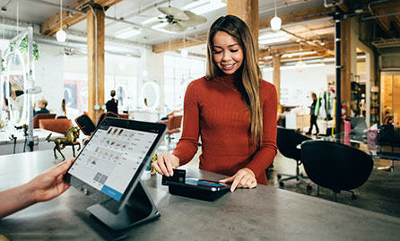 Female swiping credit card at POS